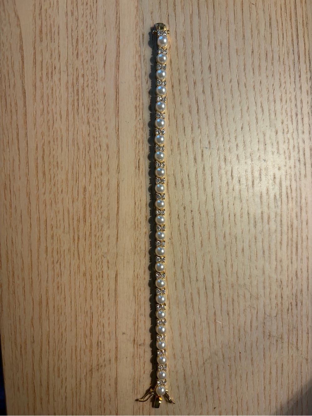 Gold tone tennis bracelet with pearl and diamond accents